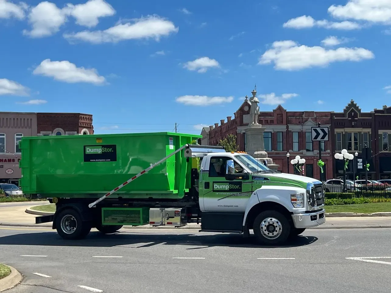 Commercial dumpster being delivered at a Birmingham business