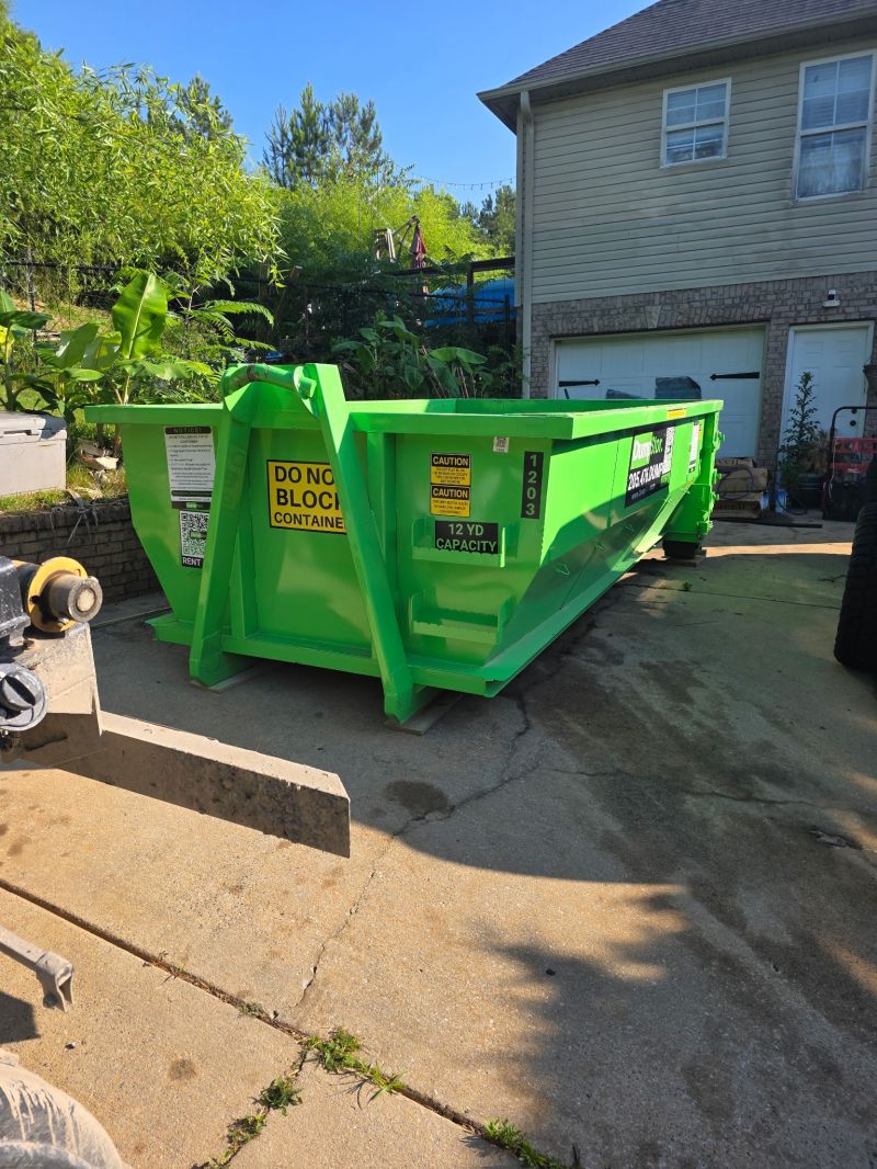 12 yard construction dumpster placed on a residential driveway